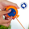 A hand holds an orange retractable clothesline with a blue handle and a yellow cord.