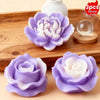 Three silicone molds shaped like purple and white roses and peonies displayed on a wooden board.