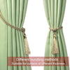 Two light green curtains tied back with gold tassel tiebacks