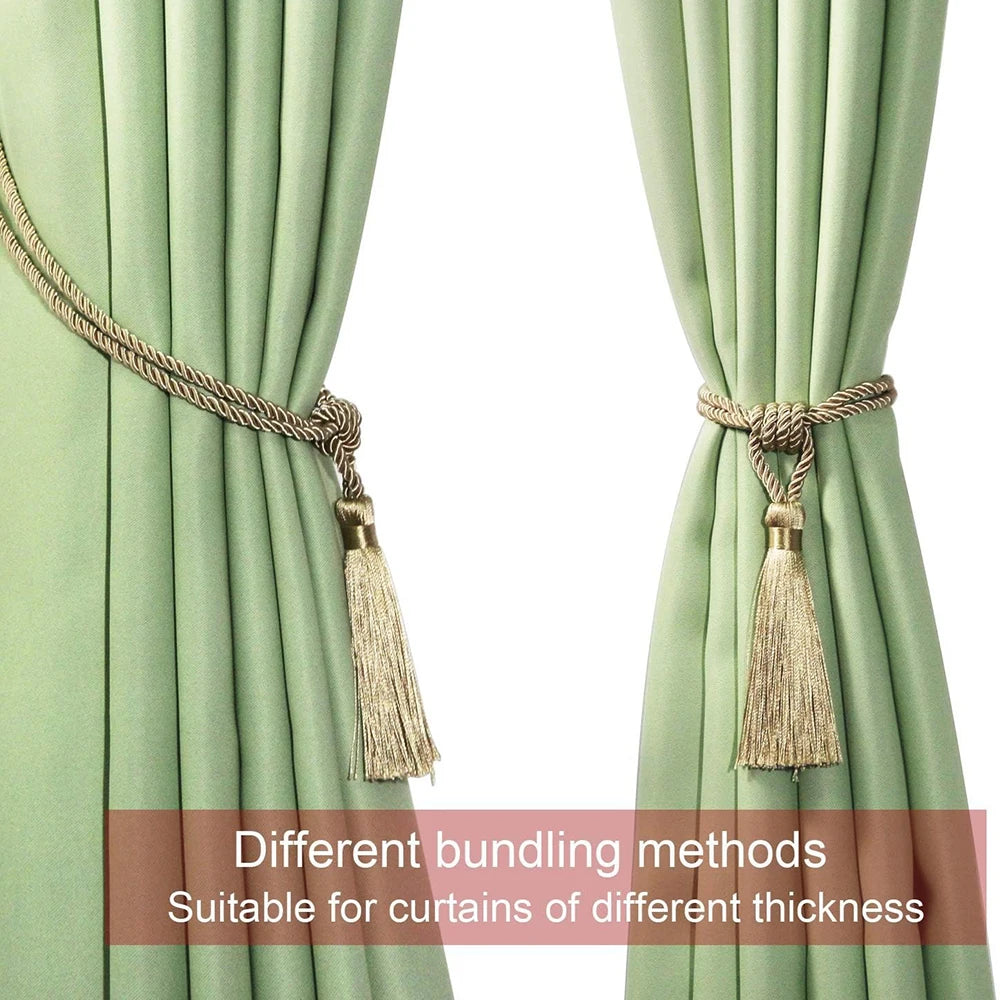 Two light green curtains tied back with gold tassel tiebacks