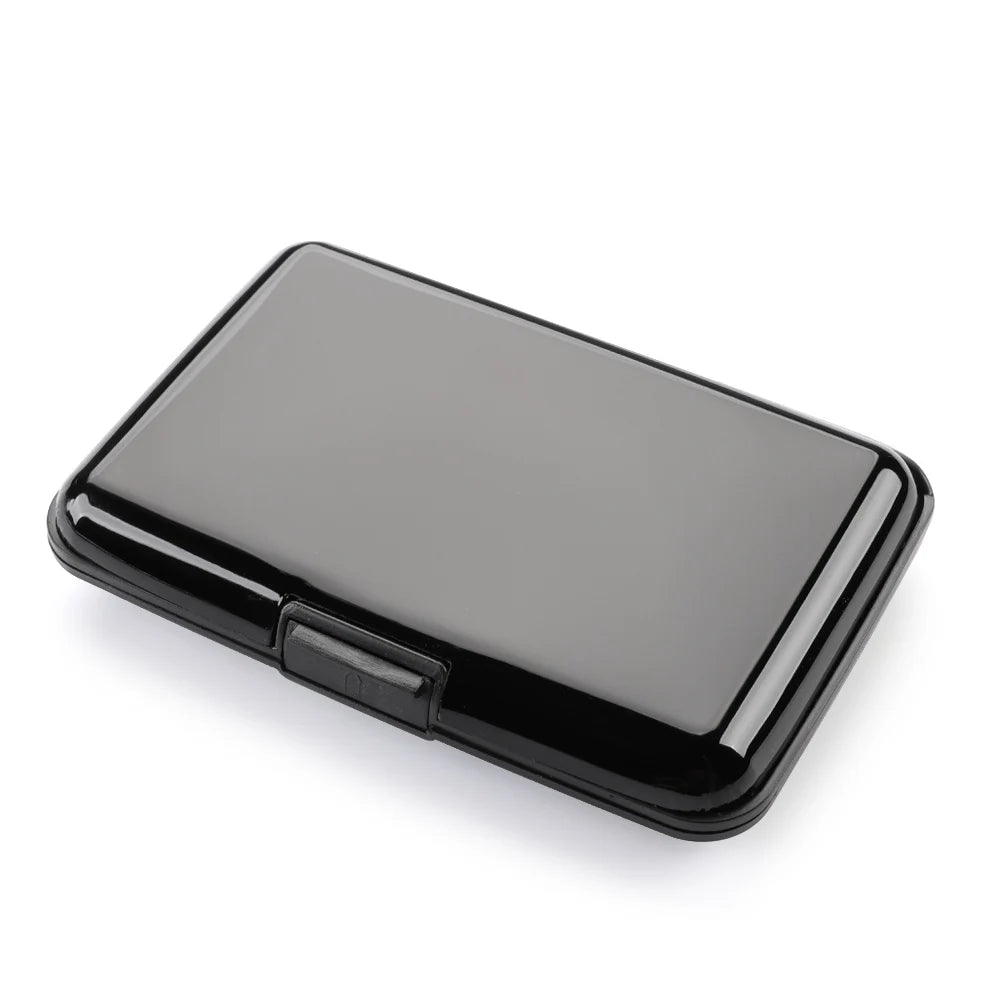 A black slim aluminum card holder with a rectangular shape shown from above.