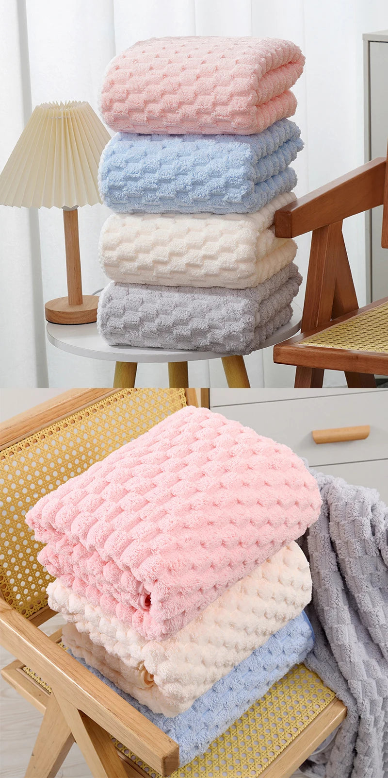 Stack of pink, blue, and beige plush velvet bath towels on a wooden surface.
