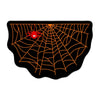 A black decorative rug featuring an orange spider web design with a red ghost in the center.