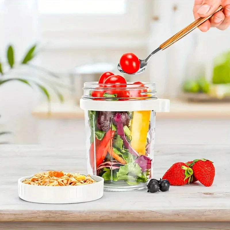 A hand is using a spoon to lift cherry tomatoes from a glass jar of overnight oats for breakfast.