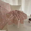 Pink lace double-layer folding umbrella shown folded on a white surface.