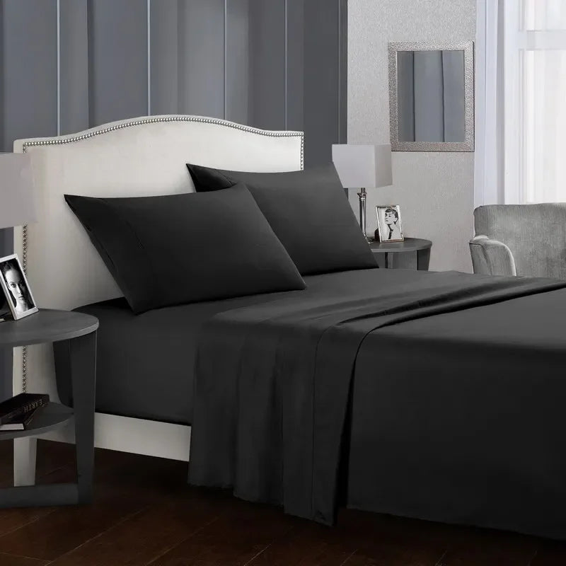 A dark gray bedroom featuring a bed dressed in a matching soft brushed microfiber bedding set.