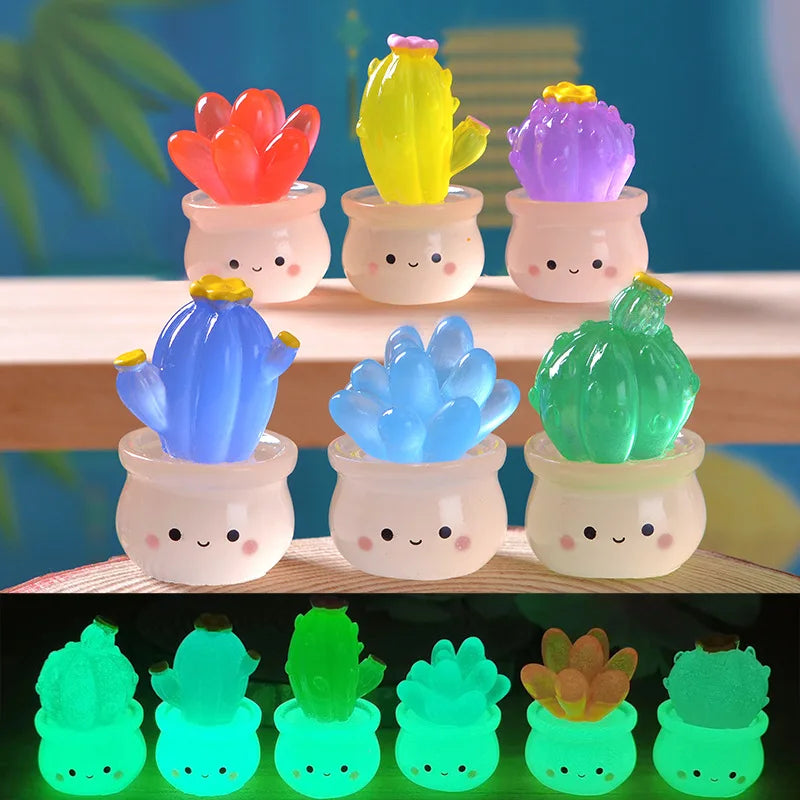 A collection of luminous succulent cactus miniatures in various colors like pink, yellow, purple, and green displayed in smal