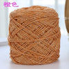 A ball of metallic silk crochet yarn in a coppery gold color used for knitting and macrame.