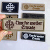 A collection of embroidered tactical patches featuring the text Time for another Crusade on various colored backgrounds.
