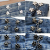 Close-up of black and white floral no-sew adjustable buttons for tightening jeans