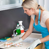 A blonde woman wearing blue gloves is cleaning a kitchen sink with plaid microfiber dish towels.