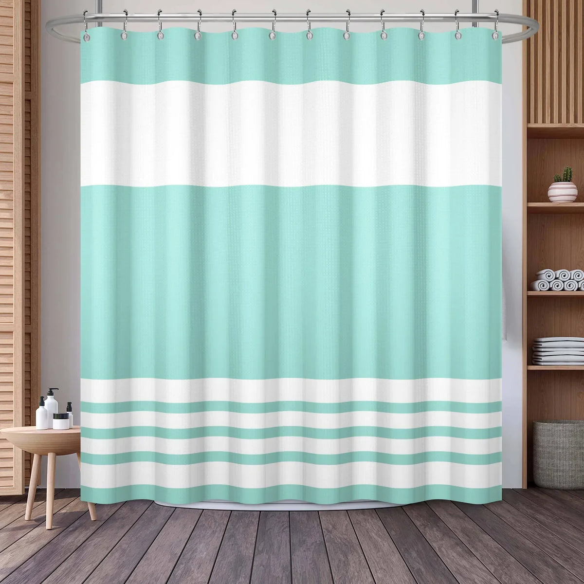 A light mint green and white striped waffle weave shower curtain hanging on a rod.