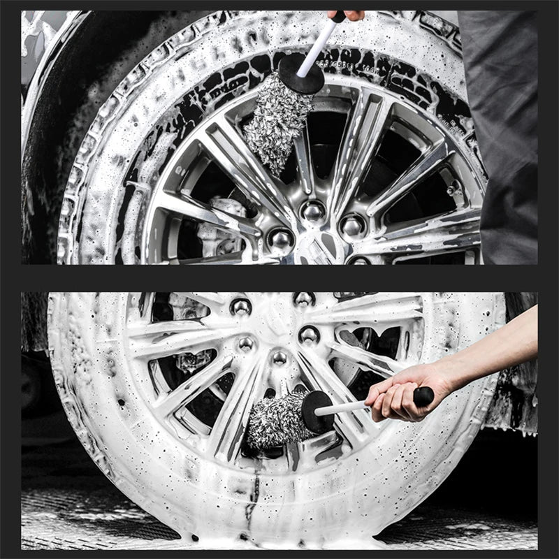 A close-up black and white photo showing a hand using a cleaning brush to clean a silver wheel rim.