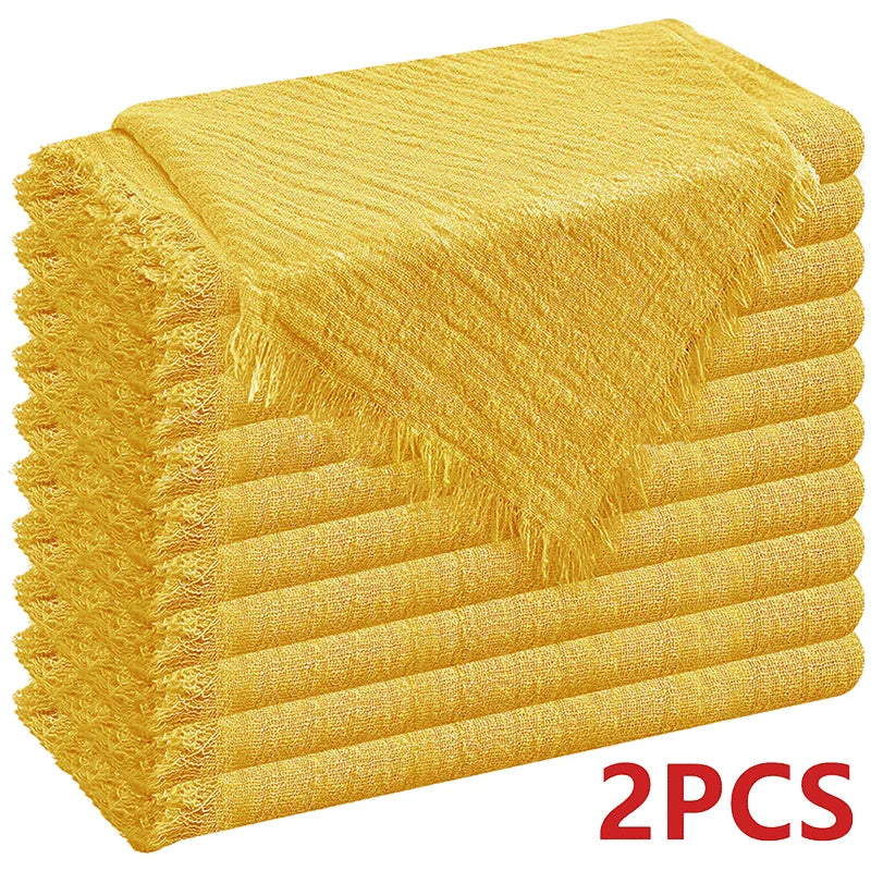 A stack of six golden yellow raw-edge polyester cloth napkins.
