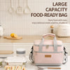 A pink insulated lunch bag is shown with utensils and food containers on a white table.