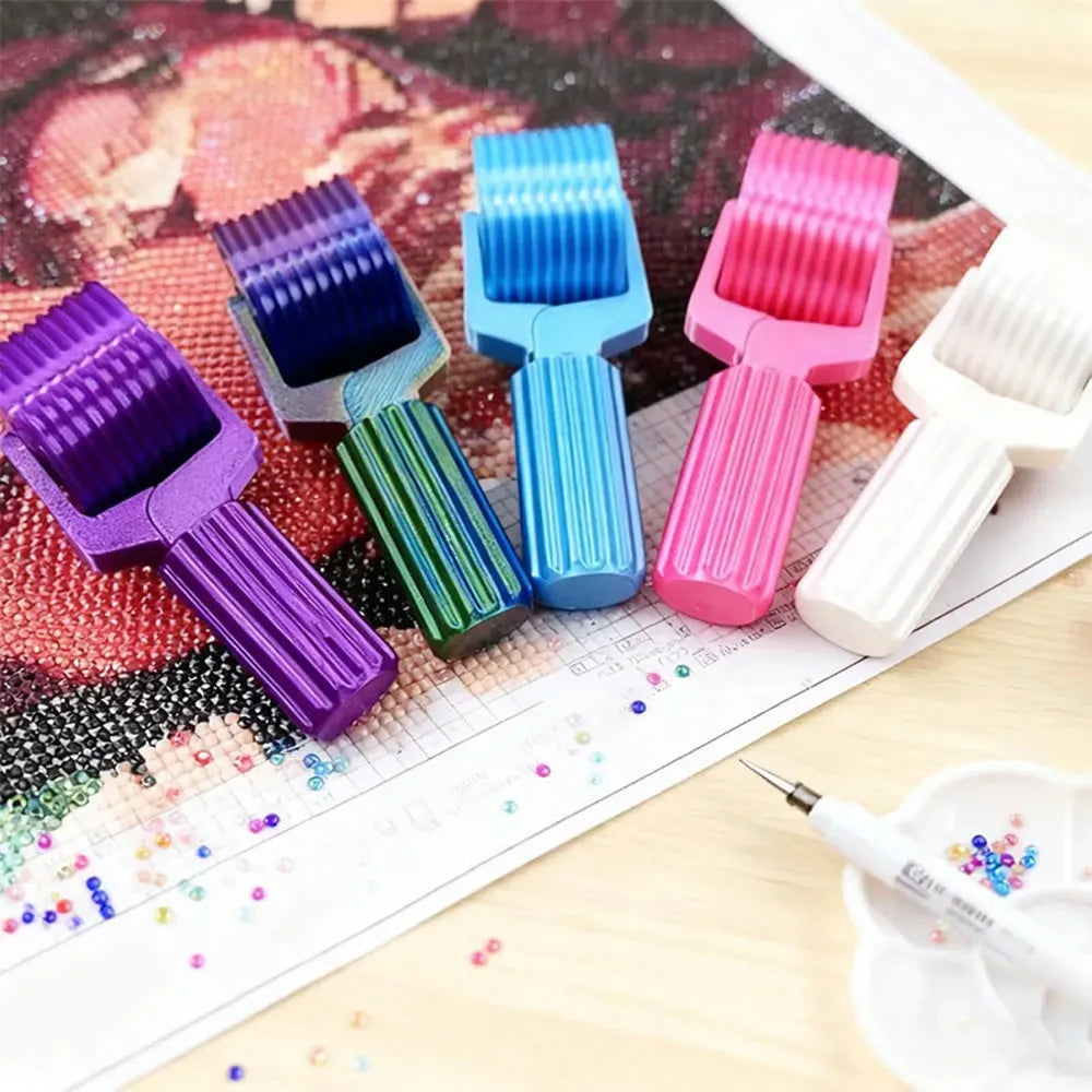 A collection of colorful, interchangeable roller tools for diamond painting, showing various shades of purple, blue, pink, an
