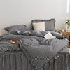 A black and white plaid duvet cover set with pillows on a bed.