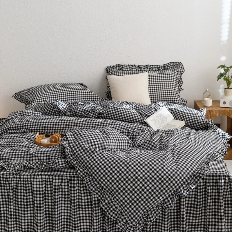 A black and white plaid duvet cover set with pillows on a bed.