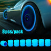 Pack of eight luminous tire valve caps with a glow-in-the-dark blue design