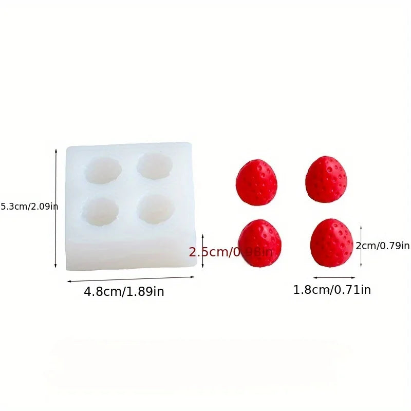 Un moule en silicone blanc avec quatre creux et trois moules sphériques rouges.