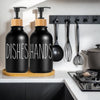 Black pump dispensers for dishes and hands with wooden accents hanging on a kitchen rack