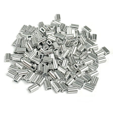 A pile of silver aluminum double barrel crimp sleeves for wire rope.