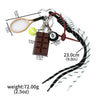A metal 8-ball keychain featuring a wooden-colored chocolate bar, a golf-like object, and a black and white braided cord.