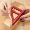 Hands measure a wooden block using a red drawing line ruler at a 45-degree angle for woodworking.