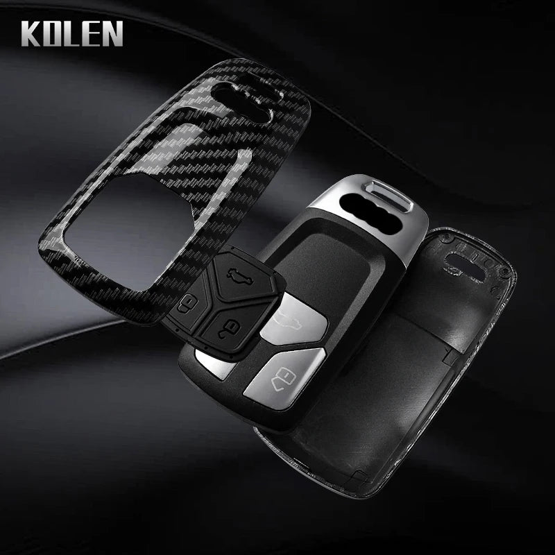 A black key fob cover with a carbon fiber style design is shown against a dark background.