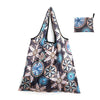 A reusable shopping tote bag featuring a dark background with floral patterns in shades of blue, pink, and beige.