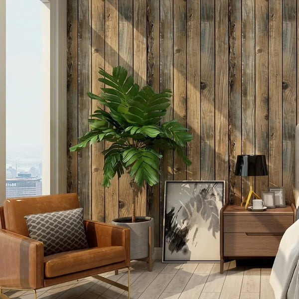 Interior shot featuring a wooden wall with vertical planks, a large green plant, and a leather armchair.