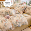 A beige floral printed duvet cover set with matching pillowcases displayed on a bed.