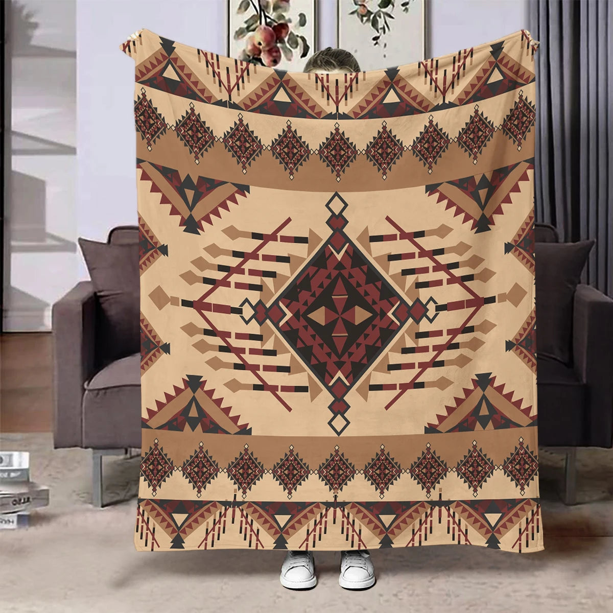 A beige flannel throw blanket featuring a geometric ethnic print in brown and maroon tones.