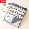 A set of foldable baby changing mats with waterproof covers and storage bags featuring various patterns.