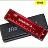 A red harmonica with ten holes is shown resting on its protective black case.