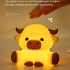 A yellow silicone night light shaped like a Highland cow, showing three adjustable brightness levels.