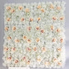 A wall panel covered in white and blush pink silk rose flowers for weddings and events.
