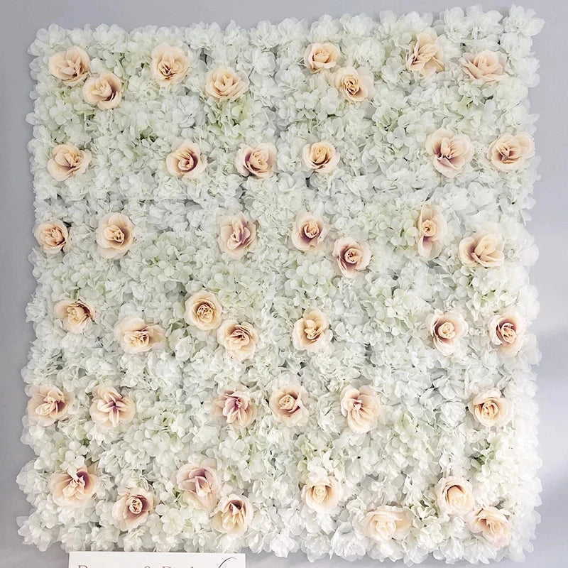A wall panel covered in white and blush pink silk rose flowers for weddings and events.
