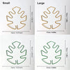 Two versions of a metal monstera plant support frame are shown, one small and one large.
