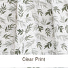 Close-up of a white muslin baby swaddle blanket with a clear green leaf print.