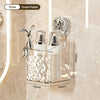 A clear wall-mounted storage basket with a water ripple design holds a silver-colored soap dispenser and a small rabbit figur