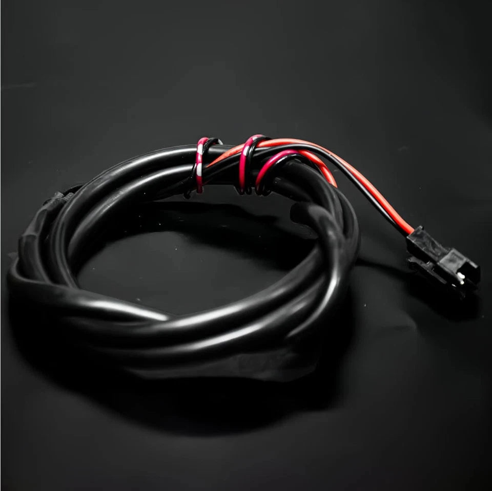 Black electrical wire with red and amber LED wires coiled and terminated with a connector.