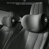 A close-up view of a black concave pillow surface support relief headrest and lumbar cushion in a car seat.