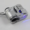 Silver handheld magnifier with storage pouch and blue UV light visible on a gray background.