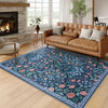 A rectangular blue and green floral vine pattern carpet mat placed on a light wood floor.