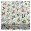 A quilted fabric pattern featuring floral and botanical prints in soft green, orange, and gray tones.