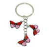 A silver hoop keychain charm featuring two red and pink butterfly charms.