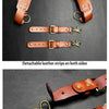 Brown leather double shoulder suspenders with brass hardware shown on a dark background.