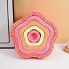 A colorful, multi-layered, flower-shaped balance stepping stone for kids' sensory and motor skills development.