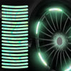 Close-up of reflective wheel rim strips installed on a dark surface.